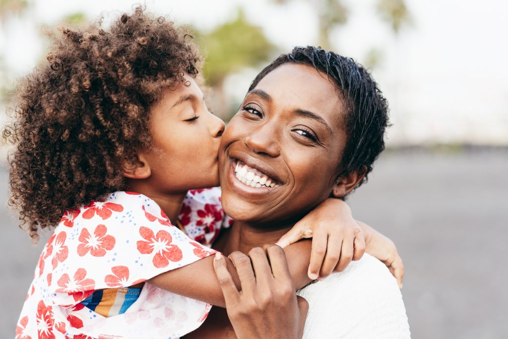 Daughter kisses her mom on the cheek